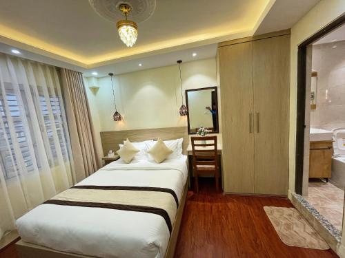 a hotel room with a bed and a bathroom at Budhanilkantha Homestay in Khadkagaon