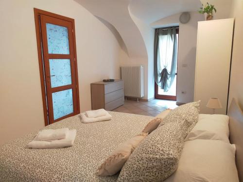 a bedroom with a large bed with two pillows on it at Dimora 5 laghi -A due passi dal Lago Sirio in Ivrea