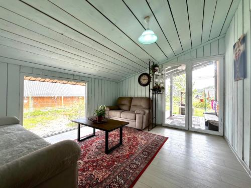 a living room with a couch and a table at Guest House Red Rock in Žabljak