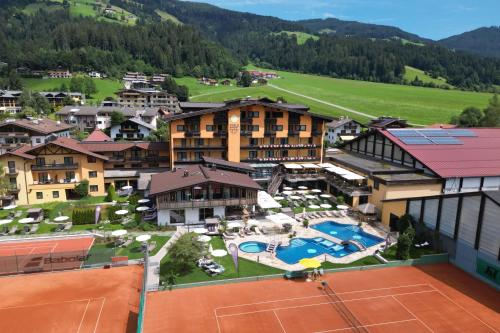 an aerial view of a resort with a tennis court at Vital & Sporthotel Brixen in Brixen im Thale
