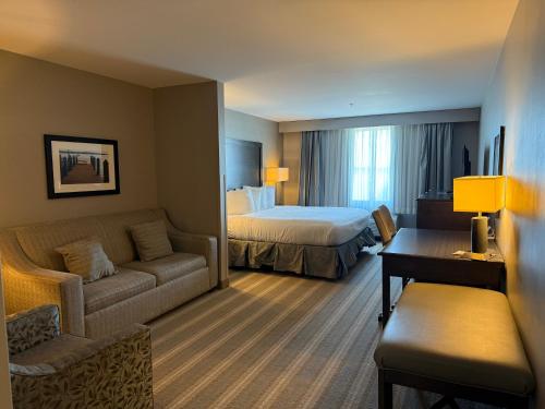 a hotel room with a bed and a couch at Country Inn & Suites by Radisson, Bemidji, MN in Bemidji