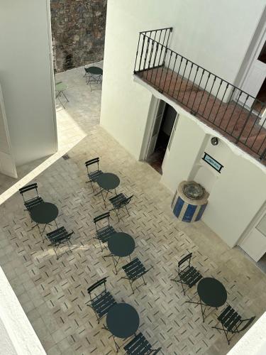 an overhead view of a room with chairs and a staircase at Casa Lahusen in Colonia del Sacramento