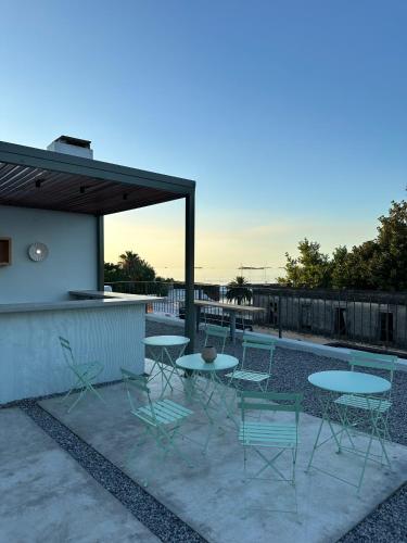 a patio with tables and chairs next to a pool at Casa Lahusen in Colonia del Sacramento