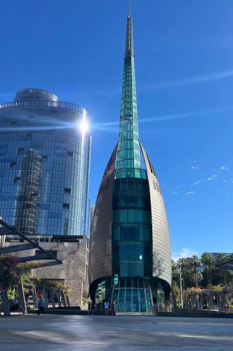 a tall glass building with a pyramid in front of it at Modern King Suite on Swan Valley Doorstep in West Swan