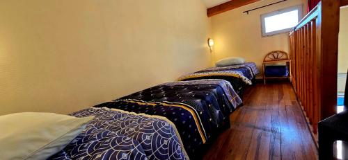 a room with two beds and a window at Hotel La Reserve in Vic-la-Gardiole