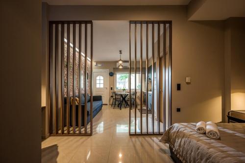 a bedroom with a bed and a living room at Herophile apartment close to airport & city center in Néa Alikarnassós