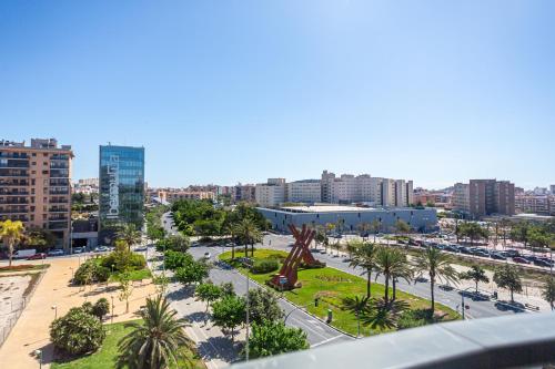 a view of a city with a statue in a park at Maya Bay Suites in Alicante