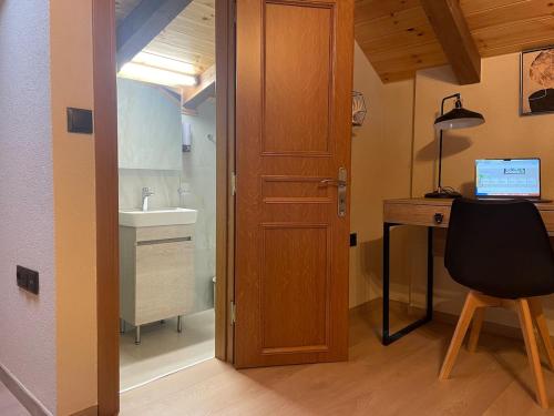a bathroom with a sink and a desk and a door at Downtown ViAlla in Chios