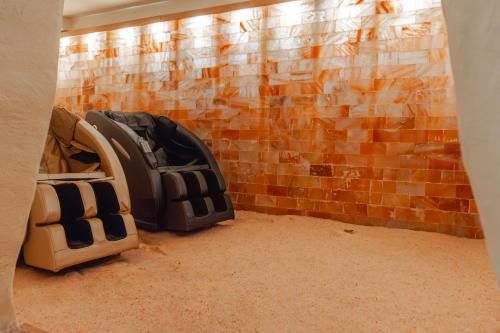 a room with a brick wall and two backpacks at La Trinità Private Spa in Corciano