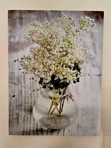 a vase filled with white flowers on a table at Hotel La Reserve in Vic-la-Gardiole