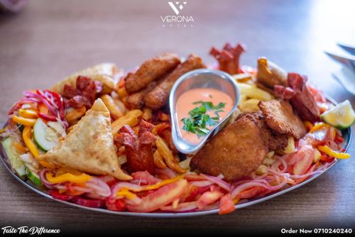 a plate of food with fried meat and french fries at Verona Hotel and Conference Center in Ruiru
