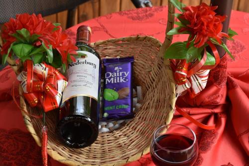a basket with a bottle of wine and a glass at Verona Hotel and Conference Center in Ruiru