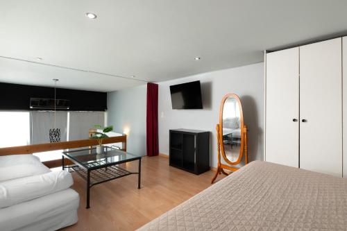 a living room with a bed and a glass table at Cavo in Ixia
