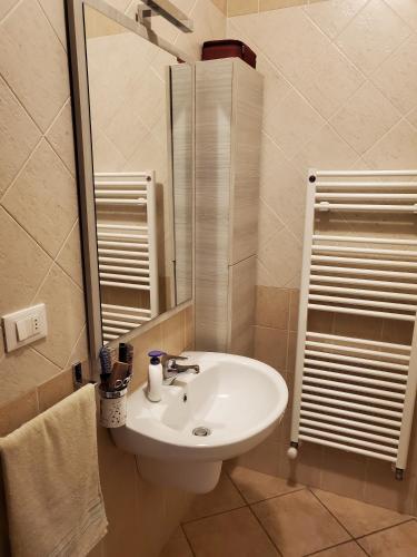 a bathroom with a white sink and a mirror at Villetta Imola in Lido degli Estensi