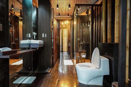 a bathroom with a toilet and a sink at Sanctuary Kanchanaburi in Ban Ai Hit
