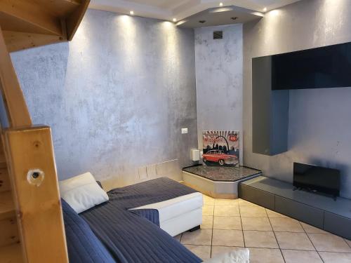 a bedroom with a bed and a flat screen tv at Villetta Imola in Lido degli Estensi