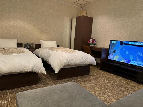 Una cama o camas en una habitación de レイクピアエンゼル山中湖