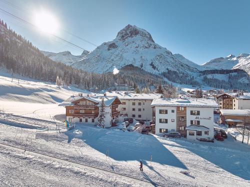 a person is skiing down a snow covered mountain at Fürmesli Appartements in Lech am Arlberg