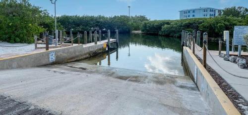 a body of water next to a walkway and a river at Key Largo 2BR 2BA Oceanfront with Pool in Tavernier