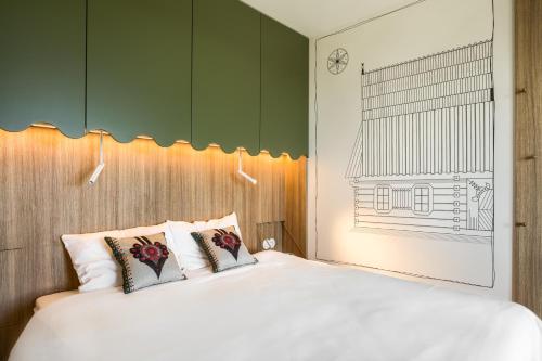 a bedroom with a white bed and green cabinets at TatryTop Słoneczna Rezydencja Jacuzzi & Sauna in Białka Tatrzanska