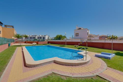 a swimming pool on the roof of a building at Descanso en la Costa in Dehesa de Campoamor