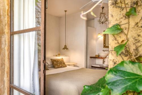 a bedroom with a bed and a window at Les Hamaques Hotel in Viladamat