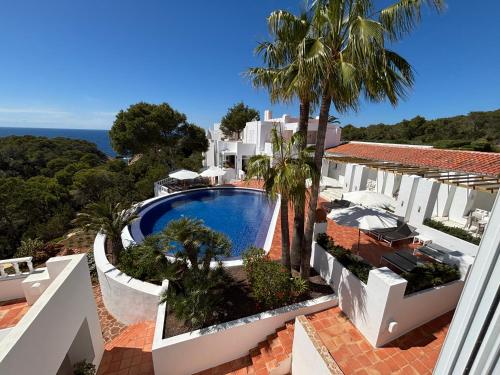 a view of a villa with a swimming pool at Hotel Village in Cala Vadella