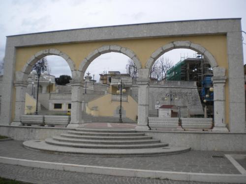 a building with three arches and stairs in front at B&B Da Luca in Grottaminarda