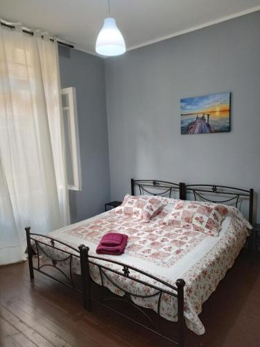 a bedroom with a bed with a blanket on it at Apartment Atiki metro shared bathroom and kitchen in Athens