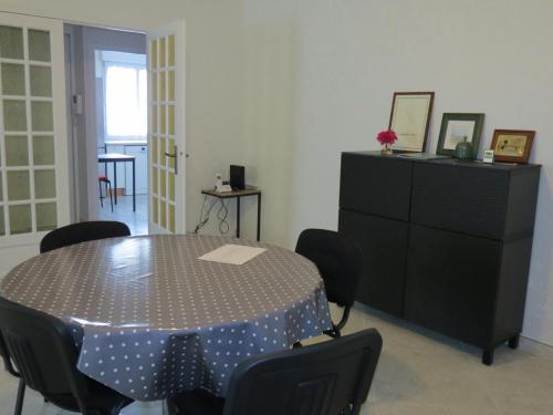 a dining room with a table and chairs and a dresser at Home SAINT-MAURILLE in Angers