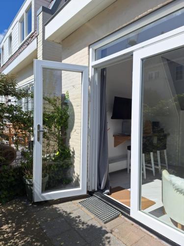 an open sliding glass door to a patio at Huisje Louis in Zandvoort