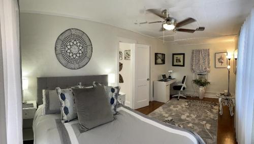 a bedroom with a bed with a ceiling fan at La Casita on Antique Row in West Palm Beach