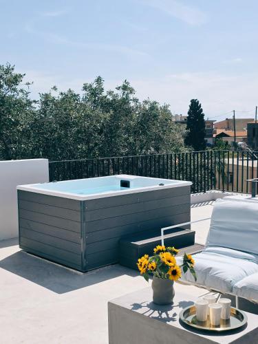 a hot tub sitting on top of a patio at Hermes&Dione in Argoulidhés