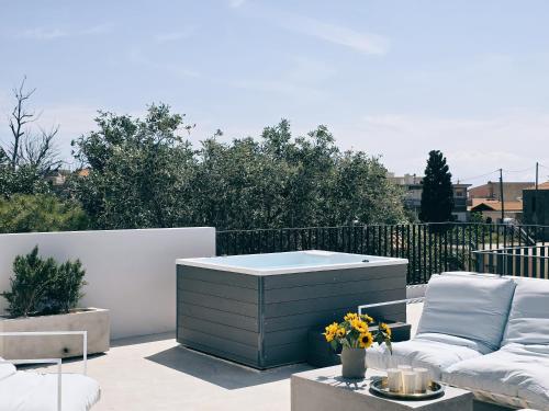 a patio with a couch and a coffee table at Hermes&Dione in Argoulidhés