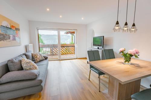 a living room with a couch and a table at Haus Nowak Ferienwohnungen in Millstatt