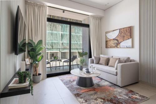 a living room with a couch and a table at Frank Porter - MYKA Residence in Dubai