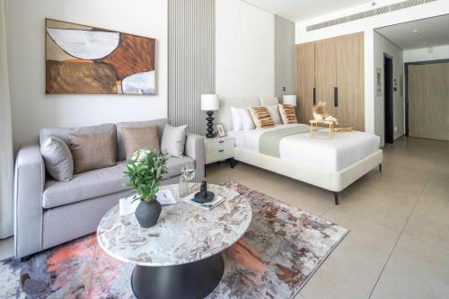 a living room with a couch and a table at Frank Porter - MYKA Residence in Dubai