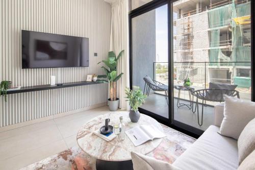 a living room with a couch and a table at Frank Porter - MYKA Residence in Dubai