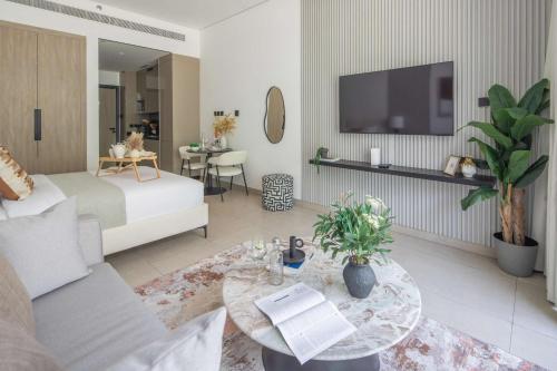 a large living room with a bed and a table at Frank Porter - MYKA Residence in Dubai