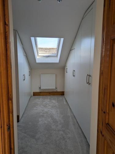 an attic hallway with a skylight in a house at Beautiful Victorian Farmhouse in Ottery Saint Mary