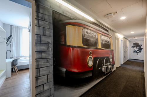 a painting of a train on a wall in a hallway at mk hotel berlin in Berlin