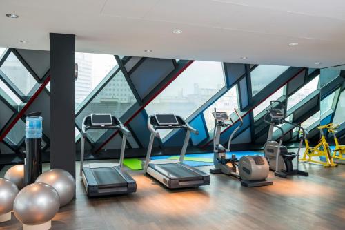 a gym with cardio equipment in a skyscraper at SO/ Vienna in Vienna