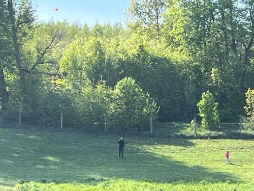 a man and a child flying a kite in a field at Cichotnia in Sorkwity