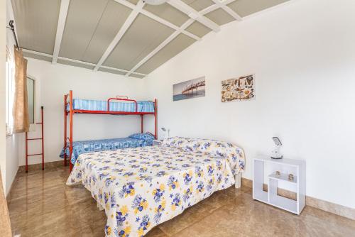 a bedroom with a bed and a bunk bed at Villetta Sofianna by BarbarHouse in Punta Prosciutto
