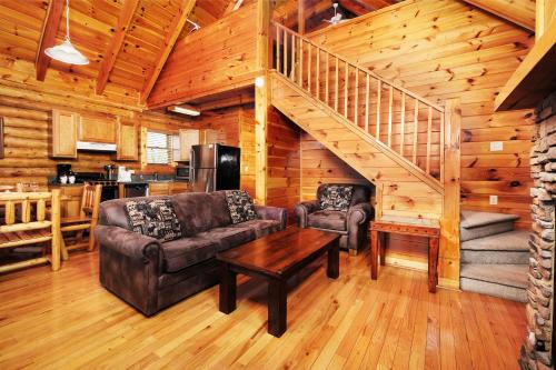 a living room with a couch and a table at 1BR2 bath log cabin sleeps 6- walk to Titanic Museum and 5 miles from Dollywood! in Pigeon Forge