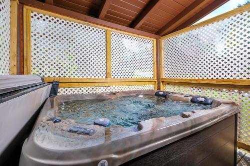 a large hot tub in a room with at 1BR2 bath log cabin sleeps 6- walk to Titanic Museum and 5 miles from Dollywood! in Pigeon Forge