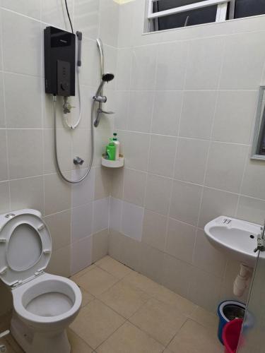 a bathroom with a shower and a toilet and a sink at BC homestay at Alma Indah in Bukit Mertajam