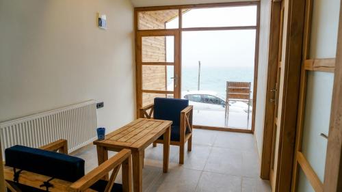 a dining room with a table and chairs and a view of the ocean at Sahil Kamp İstanbul Hotel in Sile