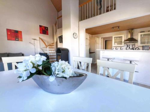 a vase of white flowers on a table in a kitchen at Ferienpark Scharmützelsee in Wendisch Rietz