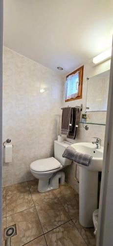 a bathroom with a toilet and a sink at Hotel La Reserve in Vic-la-Gardiole